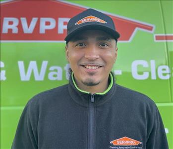 Photo of male SERVPRO employee with a green background