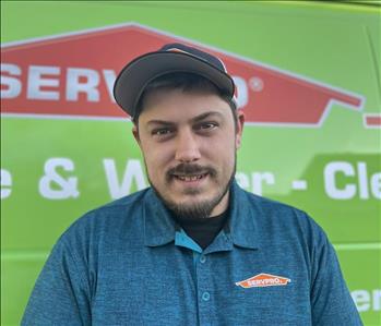 Photo of male SERVPRO employee with a green background