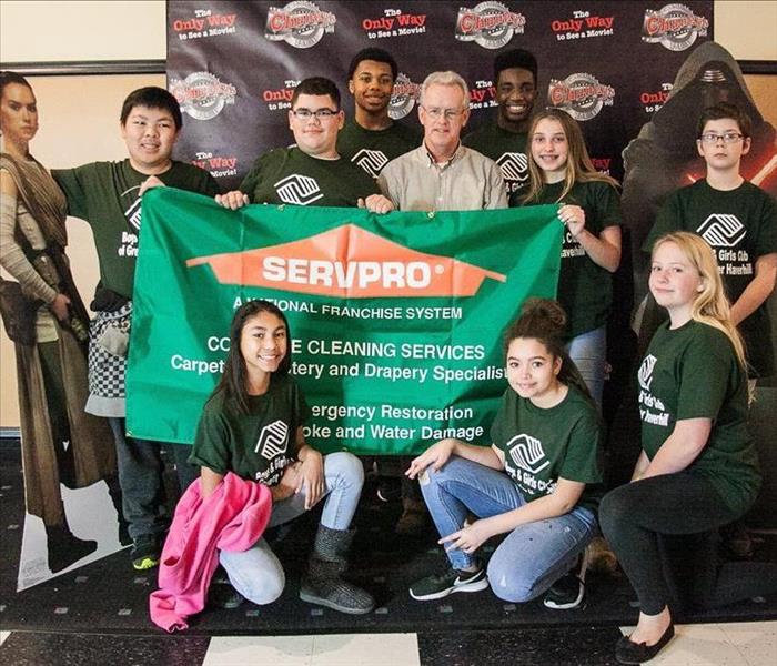 9 members of the Haverhill Boys & Girls club surround previous SERVPRO of Haverhill/Newburyport owner Dave Hart.
